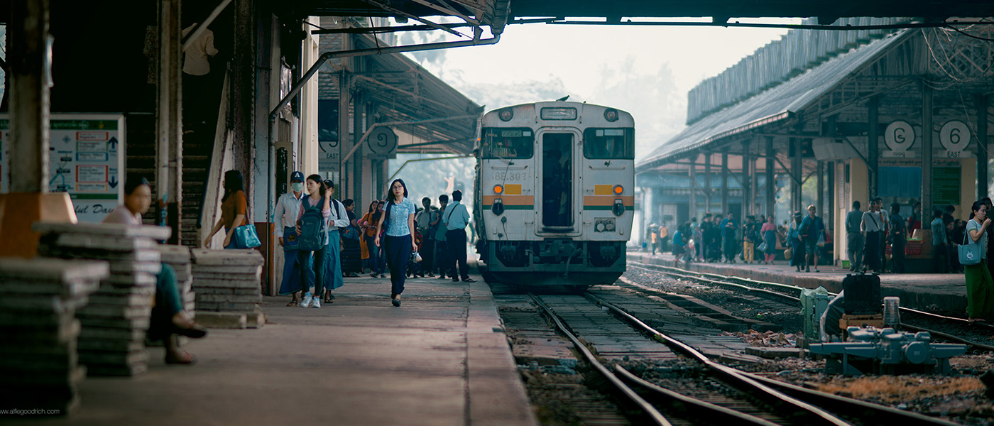 A train and busy platform at Yangon's central railway station, Myanmar